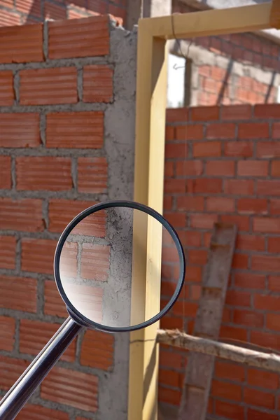 Magnifying glass over door frame installed in construction site