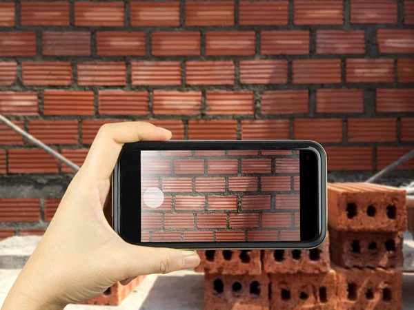 Take photography with smart phone wall brick in construction sit