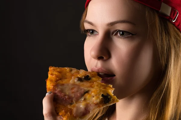 Hungry woman eating pizza