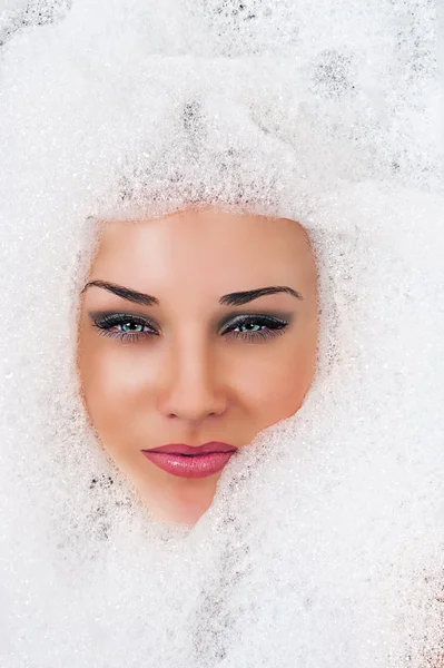 Beautiful blond woman face in the foam
