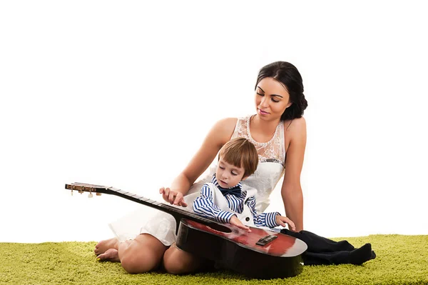 Mother and son playing guitar