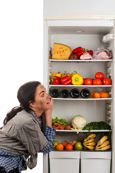 Hungry woman and a fridge full of food