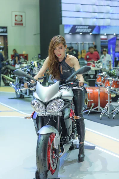 Unidentified model with Triumph motorcycle.