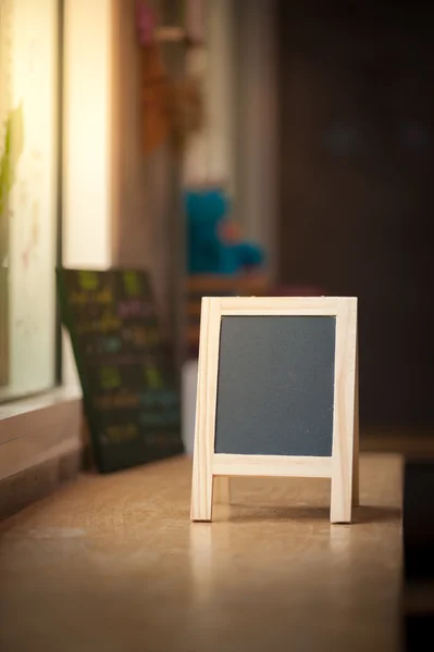A-frame black board on wood bar