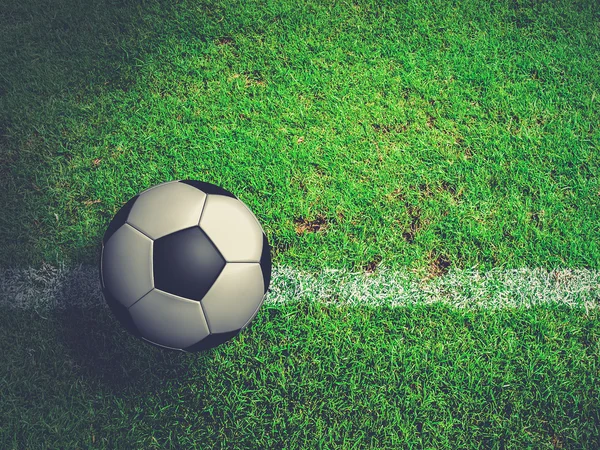 Football ( soccer ball ) in green grass field.