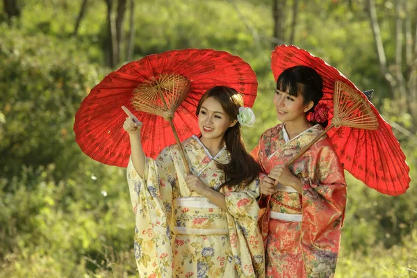 Couple asian women wearing traditional japanese kimono and red u