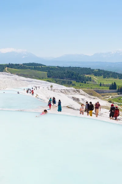 PAMUKKALE, TURKEY- APRIL,12: Tourists on Pamukkale travertines on April 12, 2015 in Pamukkale, Turkey. Pamukkale, UNESCO world heritage site, nowadays become one of the most visited sights in Turkey.