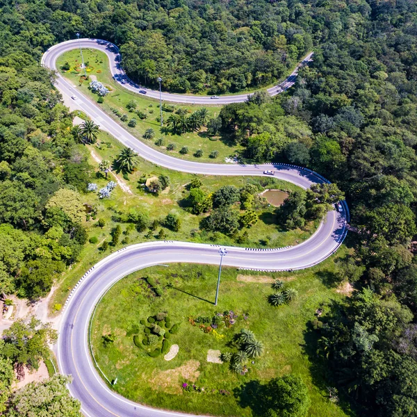 Aerial view of cars are going through a curve  road on the mountain