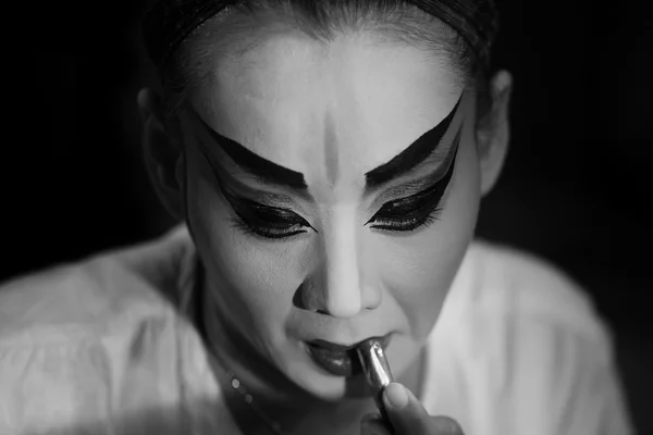 BANGKOK - OCTOBER 16: A Chinese opera actress painting mask on her face before the performance at backstage at major shrine in Bangkok\'s chinatown on October 16, 2015 in Bangkok,Thailand