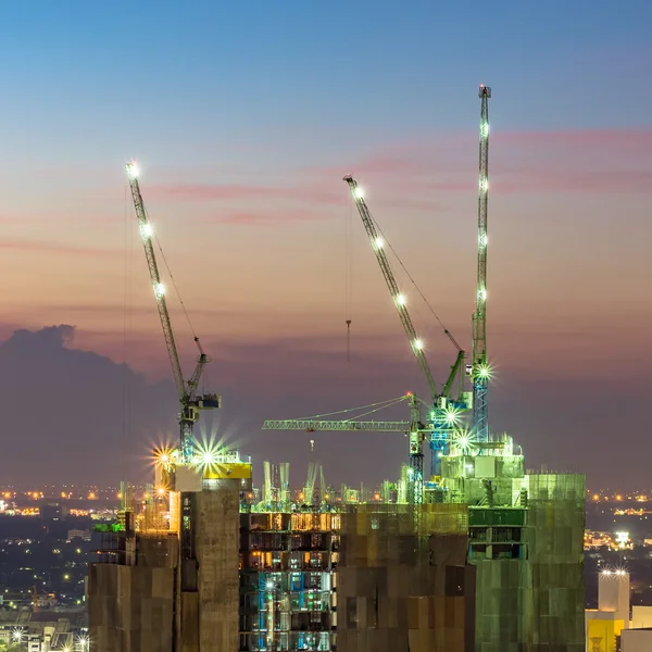 Industrial construction cranes at construction site building