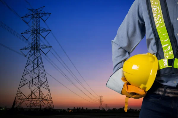 Engineer holding yellow helmet