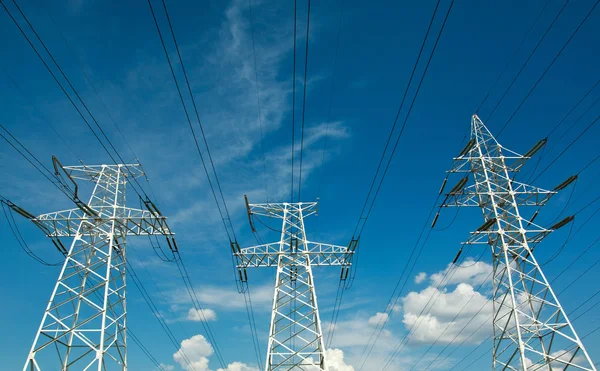 Electric line power tower on background blue sky