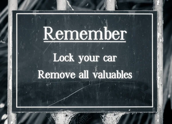 Sign Stating Remember Lock your car Remove all valuables