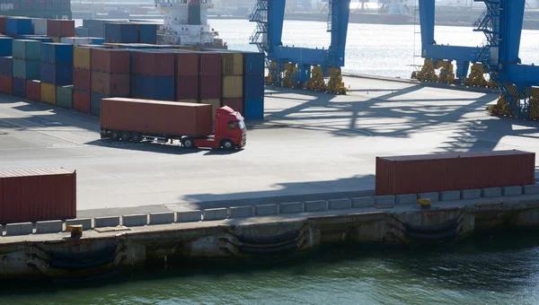Wagon carries a large container in port terminal