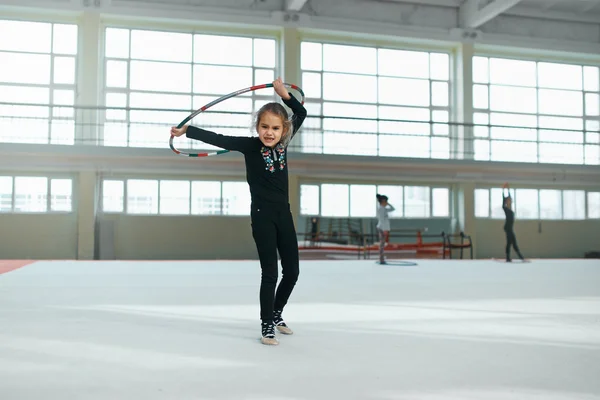 Beautiful girl gets angry with  hoop of rhythmic gymnastics.