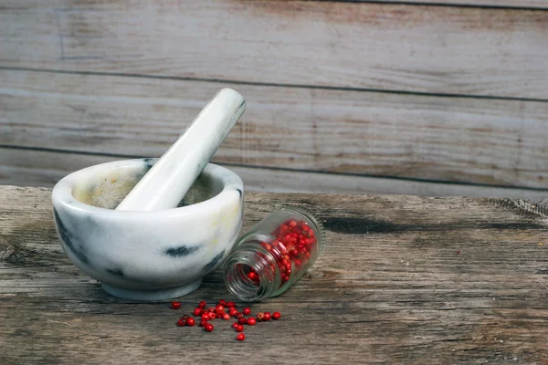 Marble mortar and pestle on old wooden table.