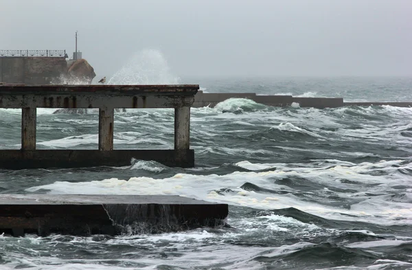 Tidal waves dash the pier during sea storm