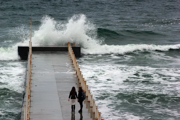 Girls looking at the sea storm