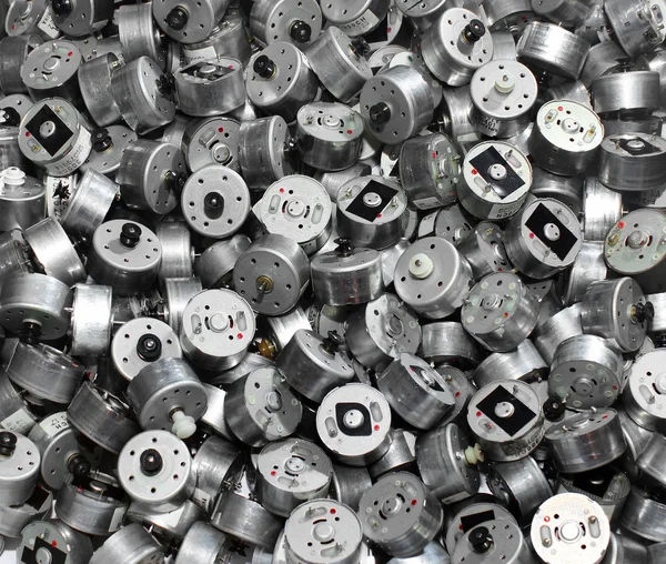 Many small used electric motors as industrial background