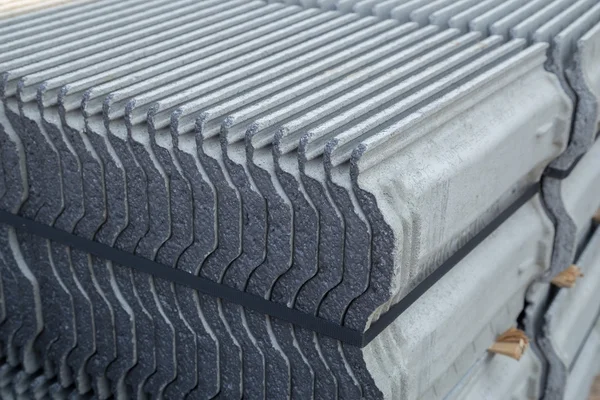 Stack of concrete roof tile (gray color) at construction site