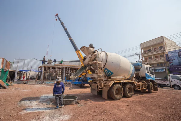 Concrete mixer truck pouring cement at construction site