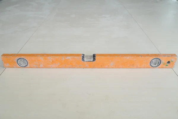 Spirit level tool on floor tile
