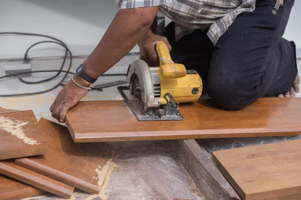 Carpenter use electric saw to sawing wood