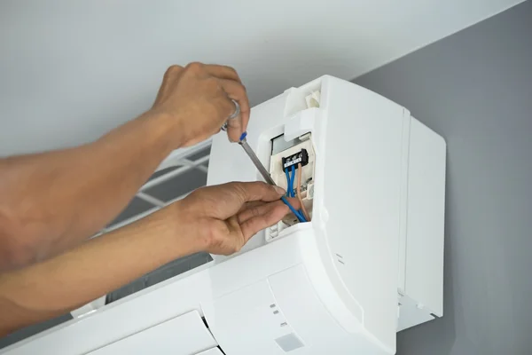 Worker installing air conditioning