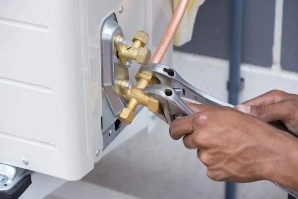 Installation of air conditioner, worker connects copper pipe