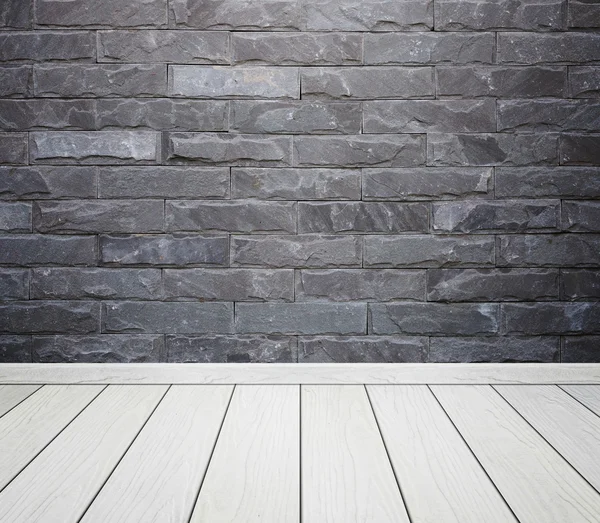 Room interior with brick stone tiles wall and wood floor backgro