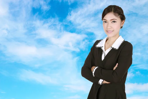 Business woman , crossed arms, with blue sky