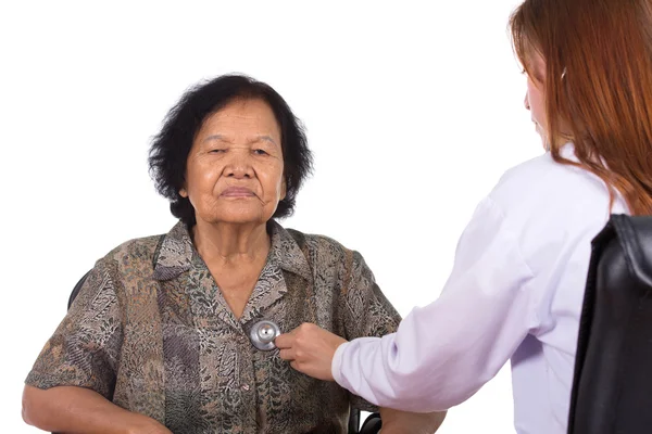 Doctor listening to elderly patient's heart