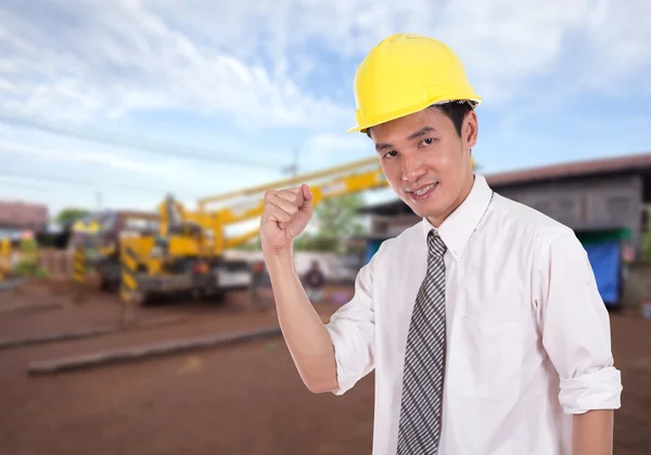 Happy engineer with arm raised, concept of successful, construct