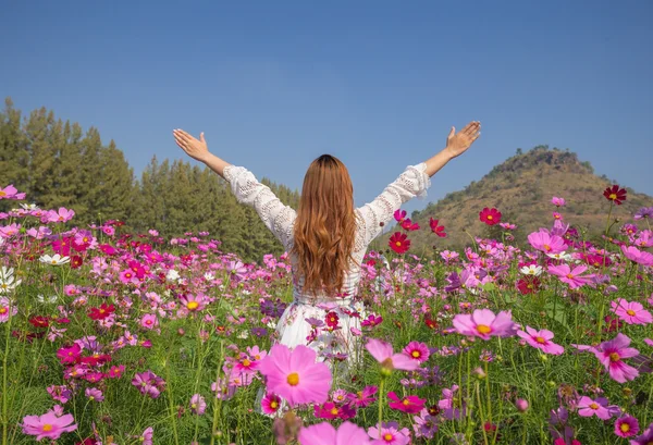 Woman with cosmos flower field