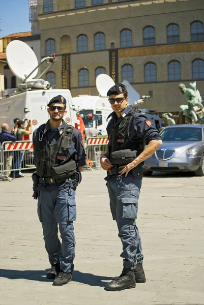 Two police officers keep order in the Piazza della Signoria