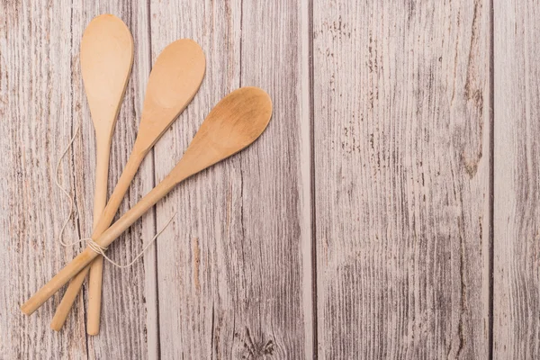 Wooden spoon tied up with a ribbon on rustic background