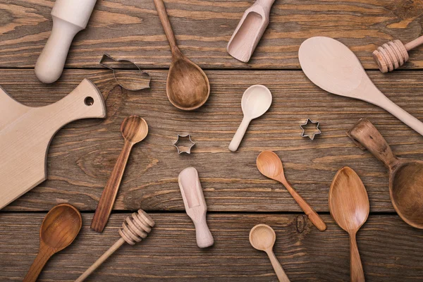 Kitchen utensils on a wooden table, top view