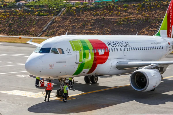 Funchal, Madeira - July 6, 2016: TAP Portugal Airbus A319-111 at Funchal Cristiano Ronaldo Airport, boarding passengers.This airport is one of the most dangerous airports in Europe