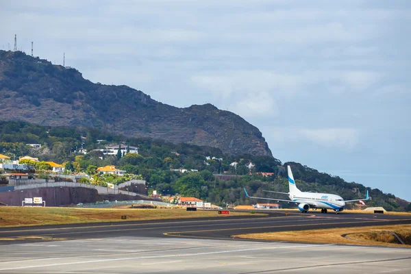 Funchal, Madeira - July 6, 2016: Enter Air Boeing 737 lands at Funchal Cristiano Ronaldo Airport. This airport is one of the most dangerous airports in Europe