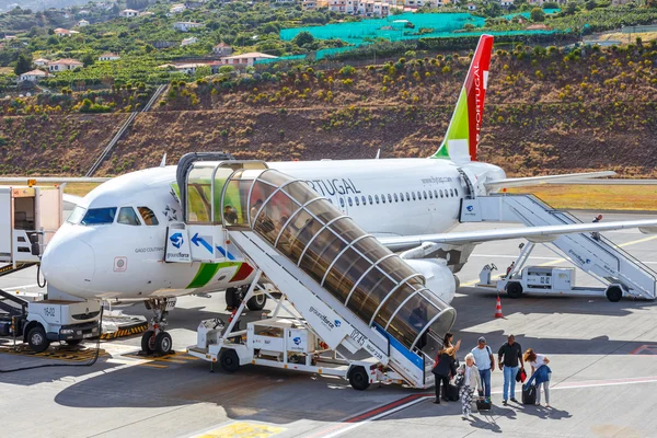 Funchal, Madeira - July 6, 2016: TAP Portugal Airbus A319-111 at Funchal Cristiano Ronaldo Airport, boarding passengers.This airport is one of the most dangerous airports in Europe