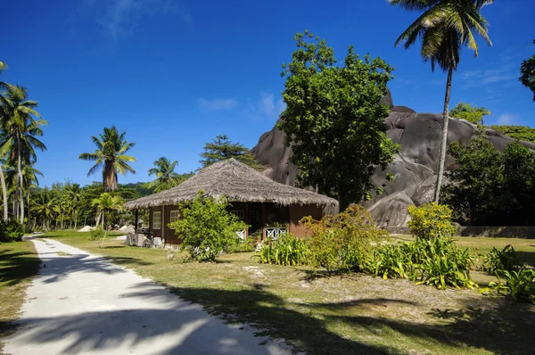 Cottage in Seychelles style with roofs of dried palm leaves, La Digue island.