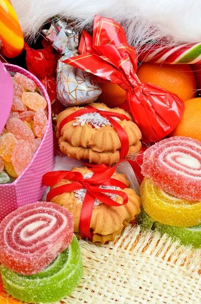 Shortbread biscuits, candies, jellies and tangerines.