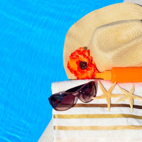 Beach hat, sunglasses, bath towel, sun spray, starfish near