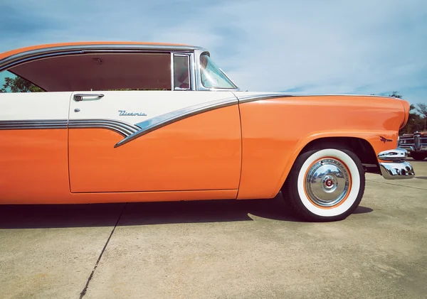 Mandarin orange and white 1956 Ford Victoria classic car