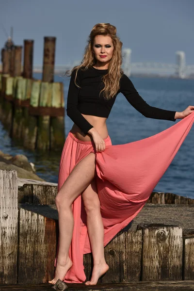 Model wearing cropped top and maxi skirt