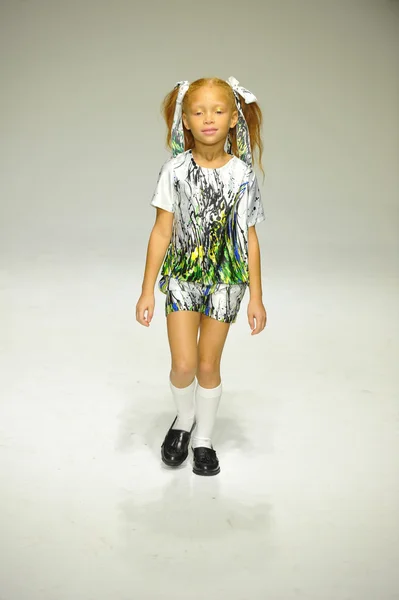 Model walks the runway during the Alivia Simone preview at petite PARADE Kids Fashion Week