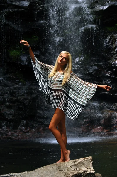 Model posing at waterfall