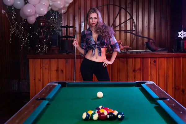 Woman in front of billiard pool table