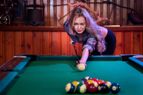 Woman posing in front of billiard pool table