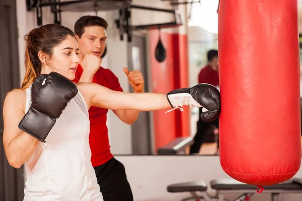 Brunette getting boxing lesson